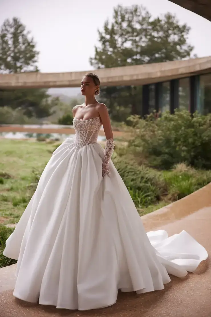 model is wearing a strapless ball gown wedding dress