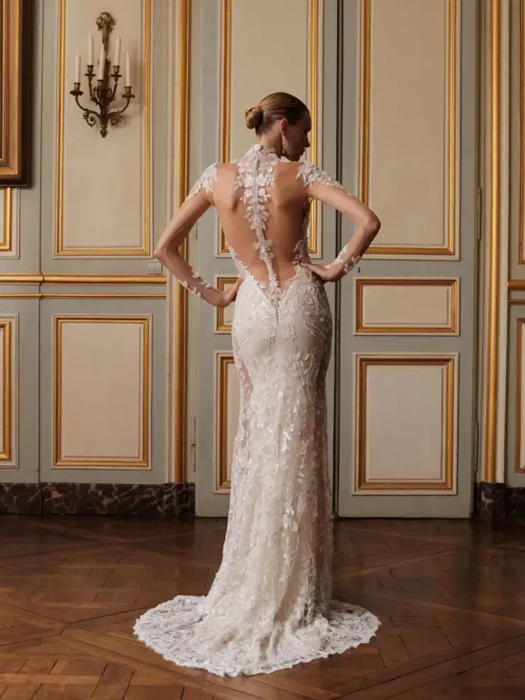 model is wearing an allover lace bridal gown by galia lahav