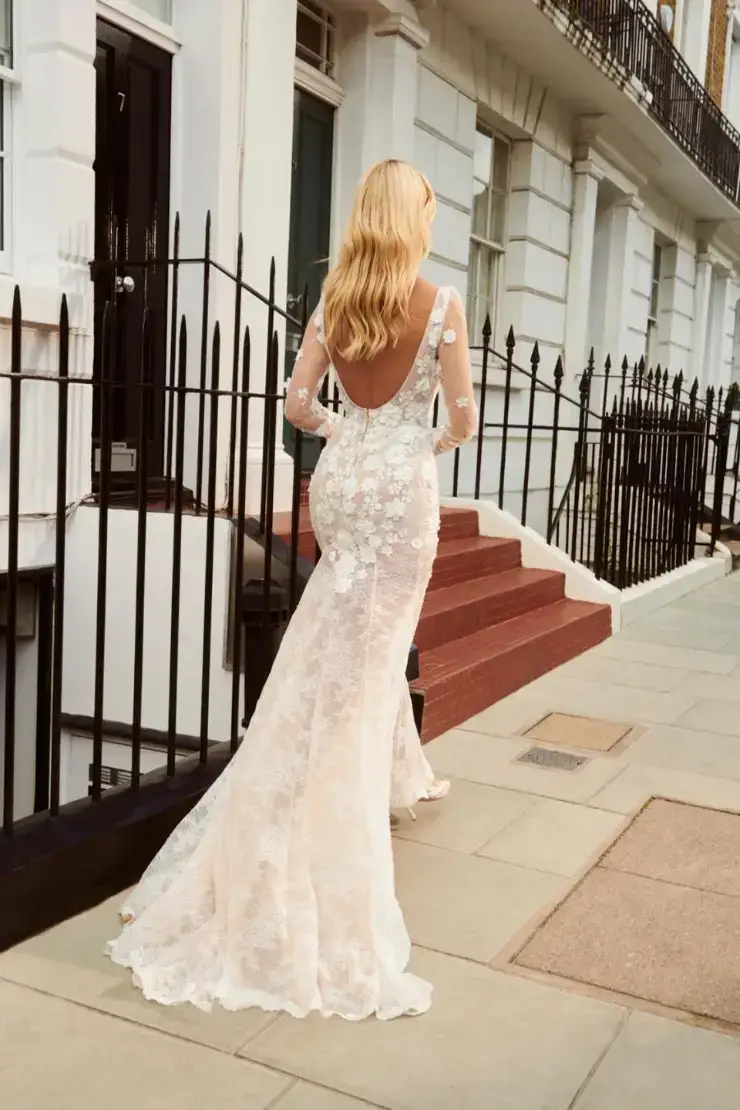 model is wearing an open back v-neckline a-line wedding dress